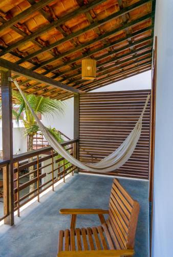 a hammock on the balcony of a house at Villa Zen Hotel in Camocim