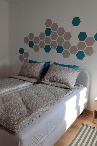 a bedroom with a bed with a hexagonal headboard at La Vista in Loznica
