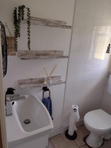 a bathroom with a tub and a toilet and a sink at 19 Seadell in Hemsby