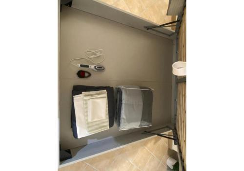 a bathroom with a shelf with towels and scissors at [Loft Comodo ed Elegante] • Wi-Fi e Colazione in Sanluri