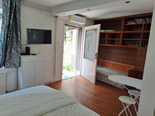 a bedroom with a bed and a table and a window at Guest House Ilica2rooms in Zagreb