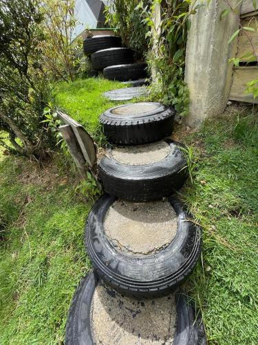 a group of tires sitting on the grass at Reserva Natural Bosque del Colibri in Guatavita