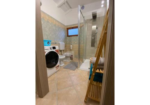 a bathroom with a toilet and a glass shower at [Loft Comodo ed Elegante] • Wi-Fi e Colazione in Sanluri