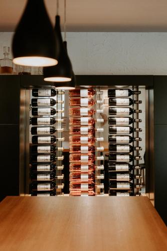 a wall of wine bottles in a wine cellar at Hôtel Le Petit Castel in Antibes