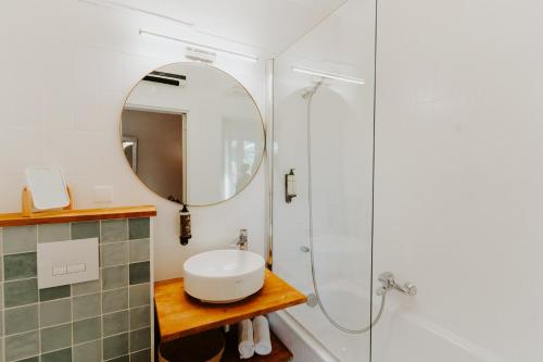 a bathroom with a sink and a mirror at Hôtel Le Petit Castel in Antibes
