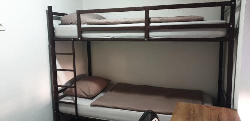 two bunk beds in a room with a table at Villa Alma in Vipava