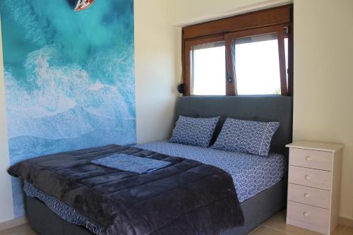 a bedroom with a bed and a painting on the wall at Petra in Afitos