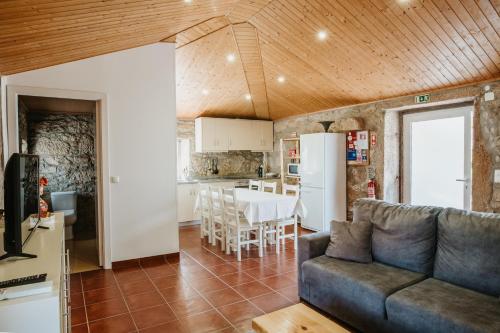 a living room with a couch and a kitchen at Forno House - A Cabana in Vila Praia de Âncora