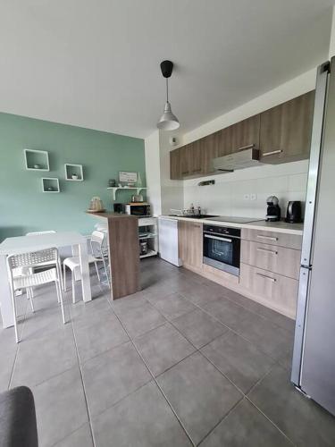 une grande cuisine avec une table, une table et des chaises dans l'établissement T2 neuf près des plages et commerces, à Sète