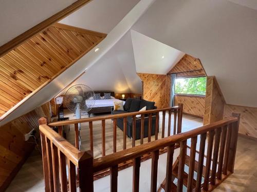 um quarto no sótão com uma escada e uma sala de estar em Digwa Beach Chalet em La Digue