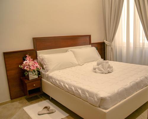 a bedroom with a bed with a pair of shoes on it at Esposizione Boutique in Rome