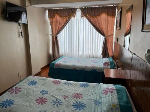 Postel nebo postele na pokoji v ubytování Hotel Cotopaxi