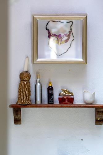 a shelf with a picture and other items on it at Art Box in Greyton