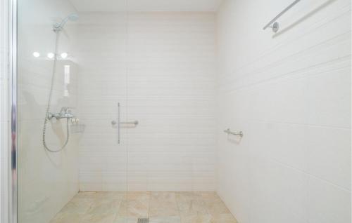 a white bathroom with a shower with a glass door at Gorgeous Apartment In Conil De La Frontera With Kitchen in Conil de la Frontera