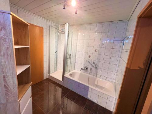 a bathroom with a tub and a shower and a sink at Ferienwohnung Schwarzalb 