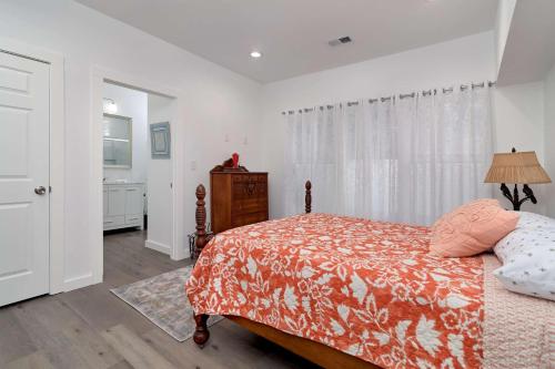a bedroom with a bed and a dresser and a window at The Mason House in Georgetown