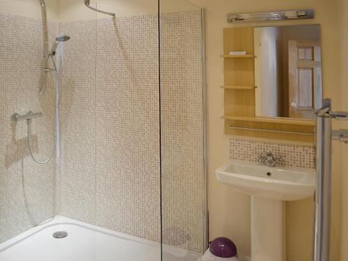 a bathroom with a shower and a sink at Kirkbride Farmhouse - 28471 in Creetown