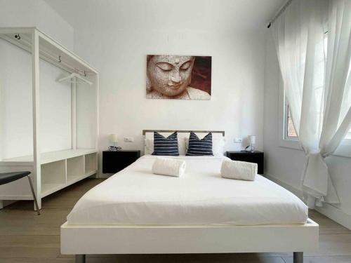 um quarto com uma grande cama branca e uma estátua na parede em @Hostourist Bcn Fira GranVia Plaza Europa-Justicia em L'Hospitalet de Llobregat