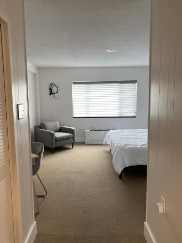 a bedroom with a bed and a couch and a window at Quaint studio apartment in Gadsden, Al in Gadsden