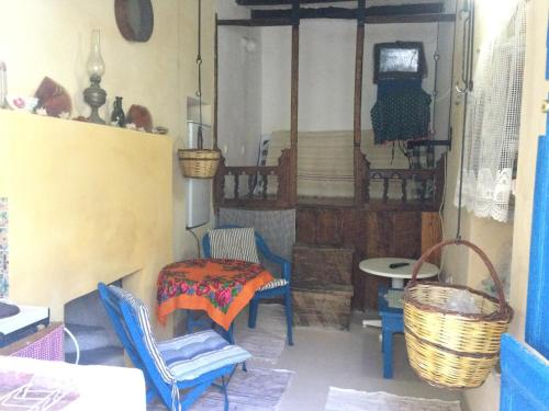 a room with chairs and a table and a bed at Olympos Traditional House in Olympos