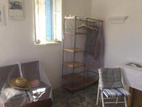 a room with a closet with a shelf and a chair at Olympos Traditional House in Olympos