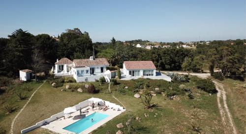 an aerial view of a house with a swimming pool at Casas da Vista II & I & 0 in Sesimbra