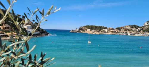 a view of a beach with a boat in the water at Hotel Marina in Port de Soller