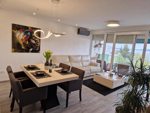 a living room with a table and a couch at Apartment ILLARIA in Rijeka