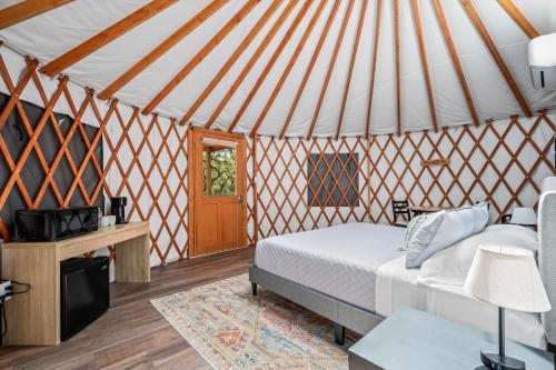 a bedroom with a bed in a yurt at OT 3515E Texas Yurt Haus 5 Yurts in New Braunfels