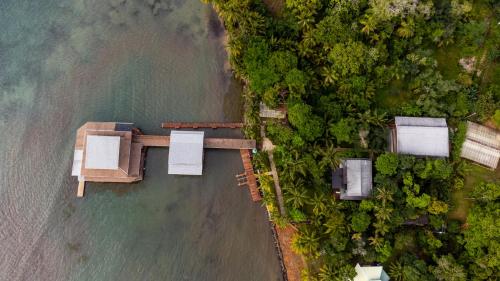 an aerial view of a house by the water at TropicalArts Resort&Studios in Bocas del Toro
