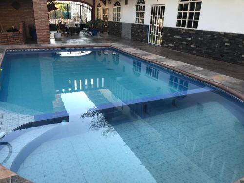 a large swimming pool with blue water at HOTEL Y VILLAS CASA AZUL in Rincon de Guayabitos