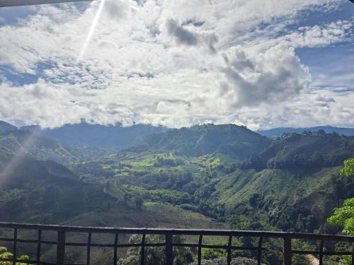 a view of a mountain valley under a cloudy sky at Finca Campestre Villa del Campo in Santa Rosa de Cabal