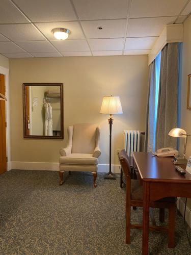 a waiting room with a chair and a table at Kingston Hotel in Vancouver