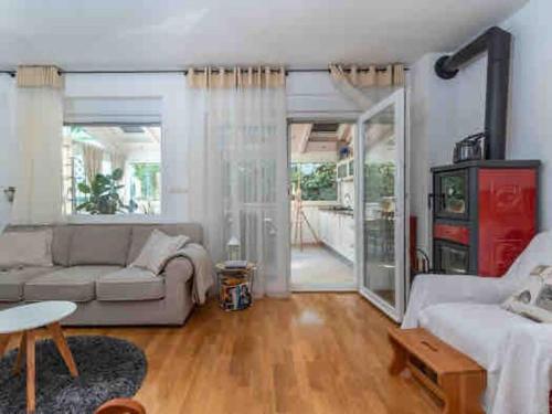 a living room with a couch and a table at Cozy House in Seget Vranjica