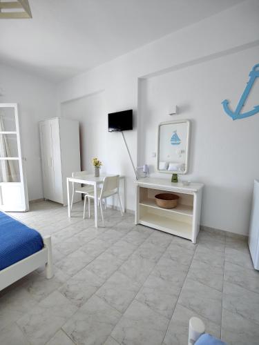 a bedroom with a desk and a bed and a table at Kleanthi Apartments in Drios