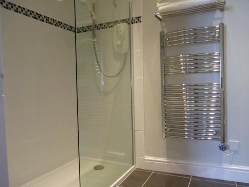 a shower with a glass door in a bathroom at Town View Alston in Alston