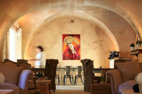 a person in a room with a painting on the wall at La Regalido in Fontvieille