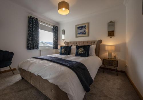 a bedroom with a large bed and a window at Canalside Apartment in Fort William
