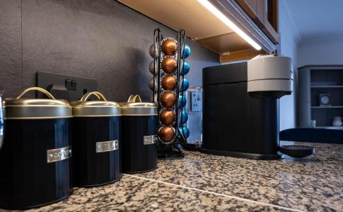 a row of trash cans sitting on top of a counter at Canalside Apartment in Fort William