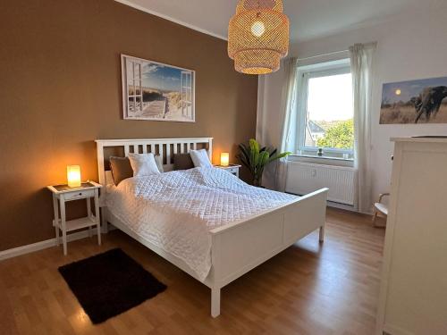 a bedroom with a white bed and a window at Dream Living 1 im Essener Süden in Essen