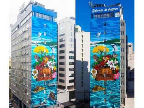 une peinture murale sur le côté d'un bâtiment dans l'établissement Home Time Studios, à Florianópolis