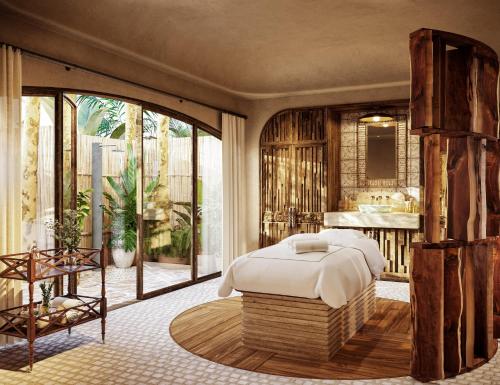 a bedroom with a bed and a large window at Maroma, A Belmond Hotel, Riviera Maya in Puerto Morelos