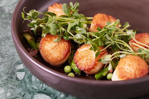 a brown bowl filled with food on a table at Kimpton - The Forum Hotel by IHG in Charlottesville