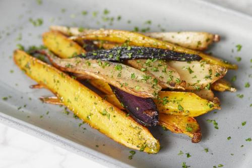 a plate of french fries on a white plate at Kimpton - The Forum Hotel by IHG in Charlottesville