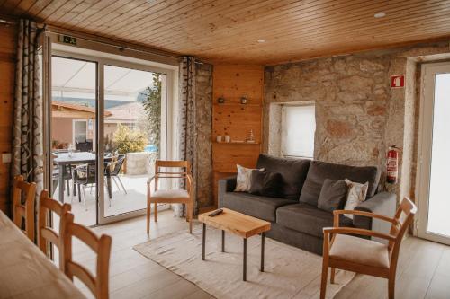a living room with a couch and a table at Forno House - O Lagar in Vila Praia de Âncora