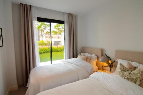 A bed or beds in a room at Mara's Apartments Higueron West - Like A House - 246 Square Meters of Private Terrace & Garden - Morning and Evening Sun