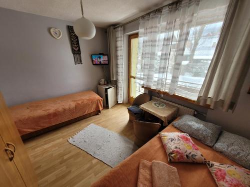a living room with two beds and a couch at Willa Helena in Zakopane