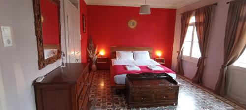 1 dormitorio rojo con 1 cama con pared roja en Kosta n`tina Guest House, en Lefkada