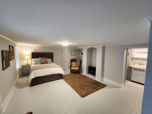 a large bedroom with a bed and a bathroom at Historic Ingleside Avenue Charm in Macon