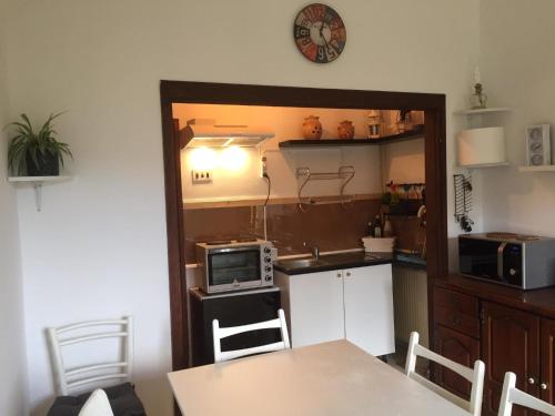 a small kitchen with a table and a microwave at Apartment Dedo in Koper